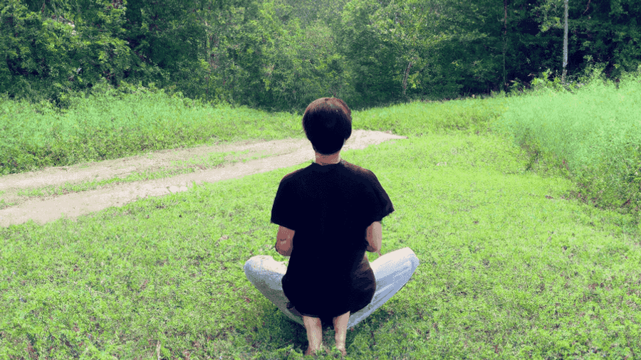 An image of a person meditating in a peaceful nature setting, symbolizing the importance of finding balance and inner peace in a busy world.