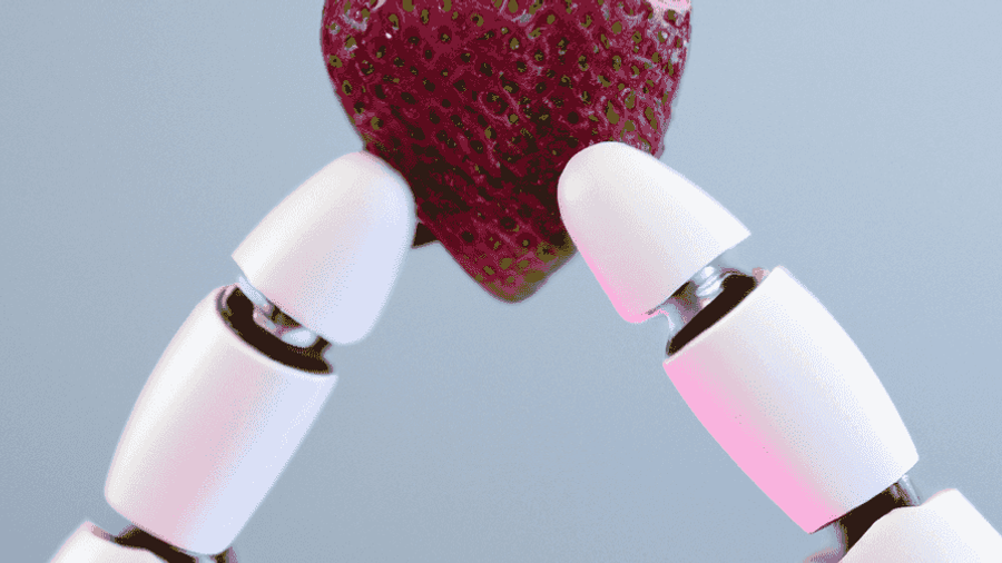 A robotic arm holding a ripe strawberry.