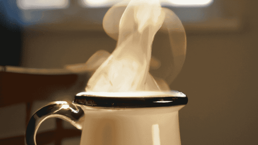 A steaming cup of coffee on a cozy kitchen table, evoking feelings of warmth and comfort.