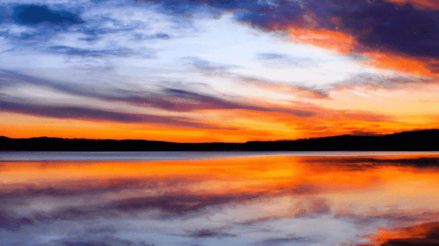 A stunning photograph of a sunset over a tranquil lake, showcasing the beauty that can be captured through digital photography.