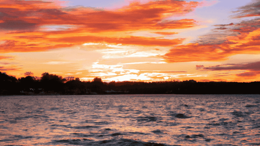 A breathtaking sunset over a tranquil lake, reflecting the vibrant colors of the sky.