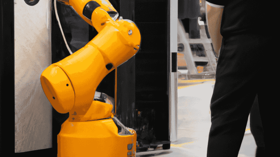 An image of a robot working alongside humans in a factory, showcasing the integration of AI into the workforce.